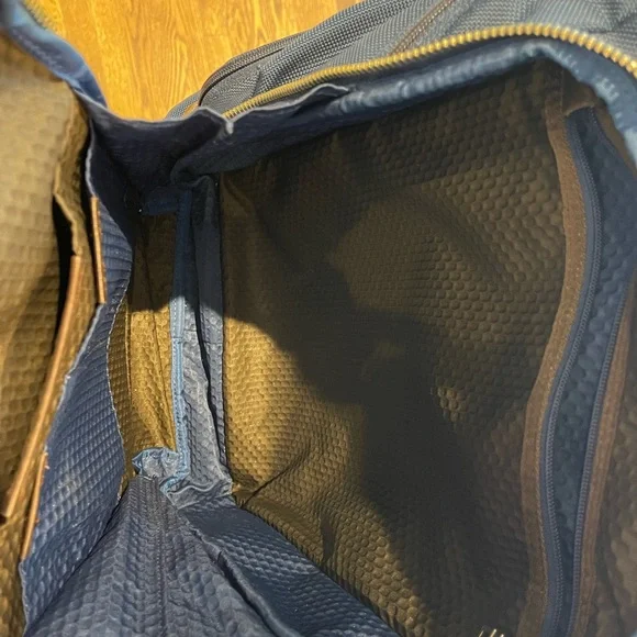 Tumi blue and black backpack. All zips & interior excellent. Two small spots.